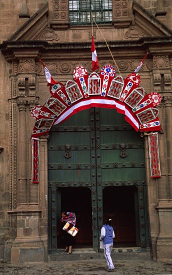 a mother with a small child leaves the cathedral through the side entrance.
